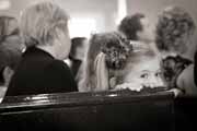 A black and white photo of child guest at a wedding.