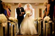 A father walking the bride down the aisle of Carmel Presbyterian Church at her wedding.