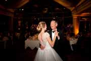 A father dances with the bride during her Beach Club wedding reception.