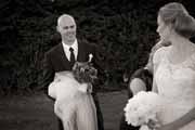 A black and white photo of newlyweds exchanging looks.