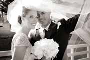 A spontaneous black and white portrait of a bride and groom.