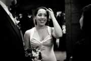 Candid black and white photo of bride adjusting hair.