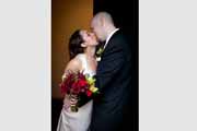 Newlyweds kiss outside their Brazilian Room reception.