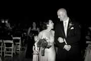Black and white photo of bride and groom during wedding recessional.