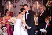 A bride and groom embrace during a church wedding ceremony.