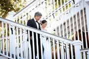 A father walks bride down stairs at Perry House in Monterey.