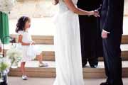 A flower girl watches a wedding ceremony at Holman Ranch.