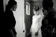 Black and white photo of a bride greeting friends.