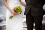 Bride holds green wedding bouquet.