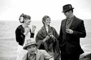 Black and white photo of newlyweds during wedding reception.