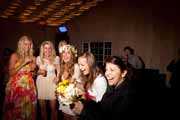 Women catch bridal bouquet.