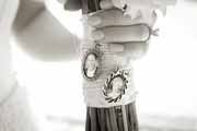 A detail bridal bouquet with photo lockets.