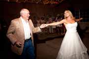 Bride dances with relative during wedding reception.