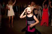 Child guest laughs during wedding reception.