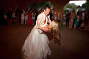 Groom dips bride during wedding dance in Holman Ranch barn in Carmel Valley.
