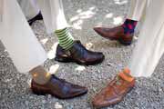 Groomsmen show off brown shoes and colorful socks.