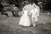 Black and white photo of newlyweds strolling among oaks at Holman Ranch in Carmel Valley.