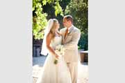 Newlyweds under Holman Ranch grape trellis in Carmel Valley.