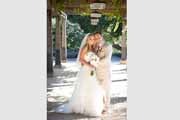 Newlyweds under a grape trellis at Holman Ranch in Carmel Valley.