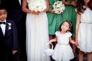 A flower girl smiles during a candid wedding portait.