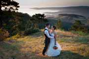 Newlyweds share a loving moment overlooking Point Lobos, California.