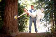 A groom carries his bride at the Amphitheatre of the Redwoods at Pema Osel Ling.
