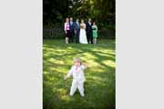 A ring boy waves during a wedding group portrait.