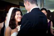 Bride looks lovingly at groom during wedding ceremony.