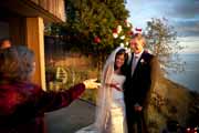 Rose petals tossed at newlyweds on deck of Post Ranch Inn Cliff House.