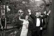 A black and white photo of a backyard wedding ceremony.