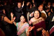 Guests dance during a sikh wedding reception.