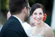 A bride gives husband a loving look during her wedding reception.