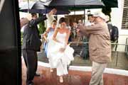 Happy bride departs the Lodge at Pebble Beach in rain.