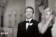 Black and white photo of groom watching bride.