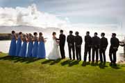 Wedding party on edge of Pebble Beach Golf Links overlooking ocean.
