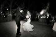 Black and white photo of bride and groom dancing during wedding reception.
