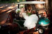 Bride rides in golf cart.