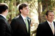 Groom waits for bride during wedding ceremony.