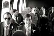 Black and white photo of groom on shuttle bus.