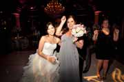 Bride and friend holding bridal bouquet.