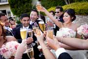 Bride and wedding guest friends share a champagne toast.