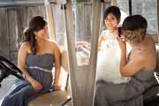 Bridesmaid snaps picture of bride in golf cart.