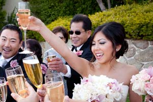 A bride toasts her wedding party with champagne.