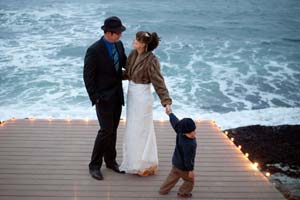 Newlyweds at dusk on coast near Half Moon Bay.