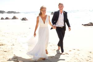 Newlyweds stroll on Garrapata Beach in Big Sur.